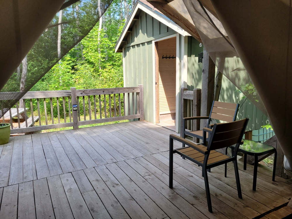 Deck and wheelchair-accessible bathroom entrance at Pine Tent glamping site