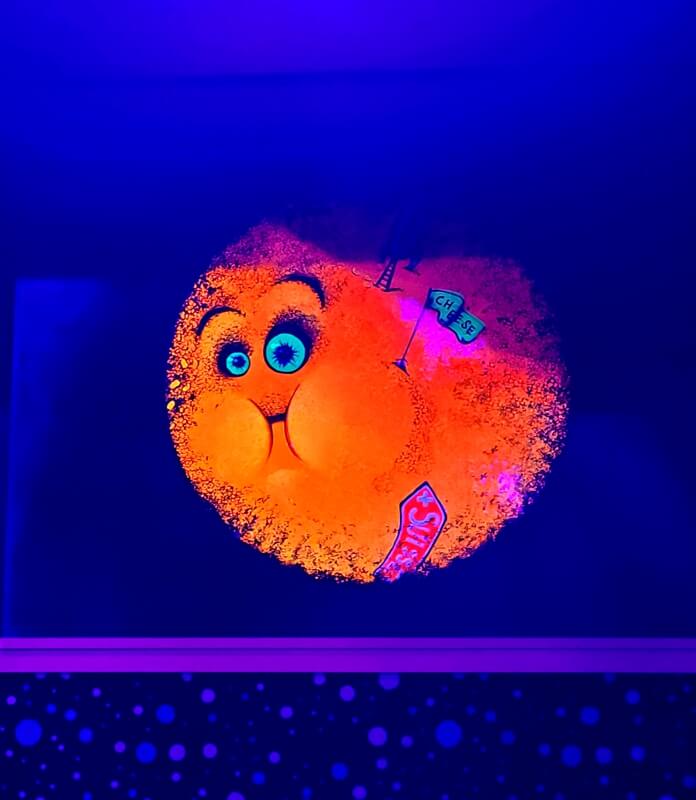 Bright neon artwork inside Putting Edge Halifax glow mini golf course.