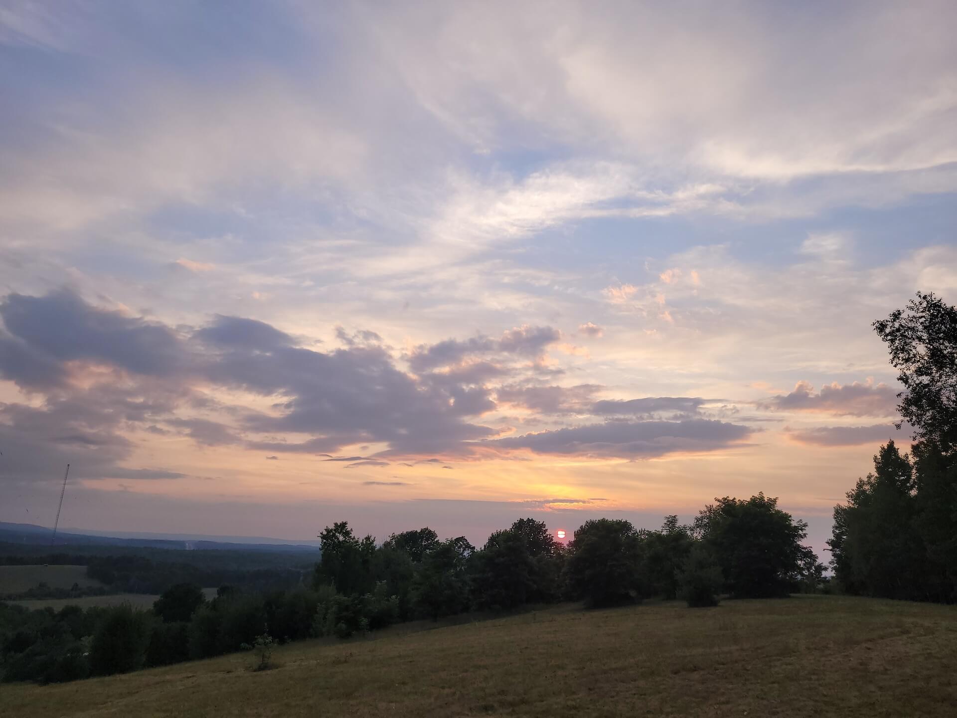Peaceful sunset view from hill at private glamping site in rural Nova Scotia